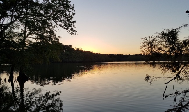 a lake with a sunrise