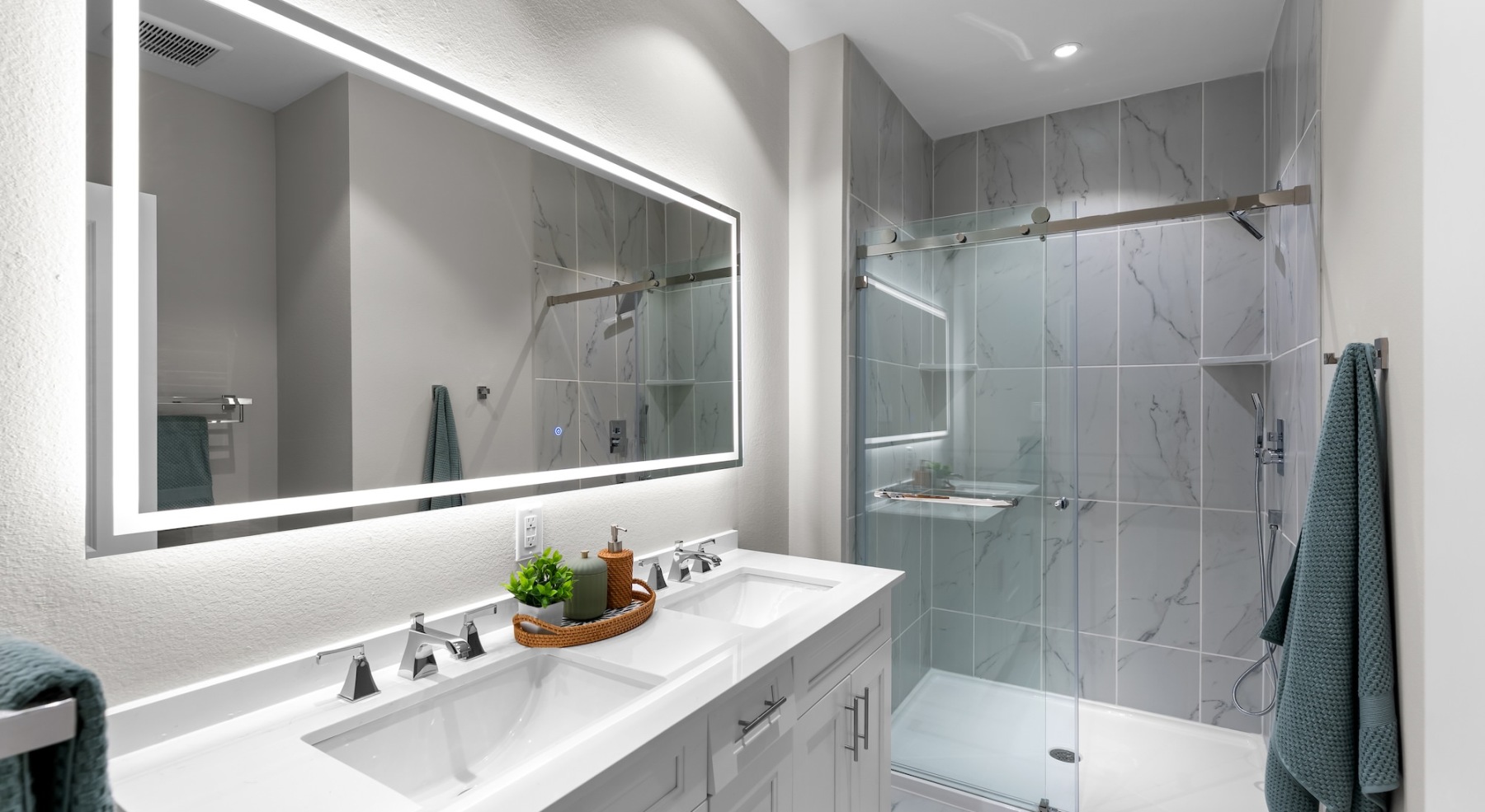 a spacious bathroom with a large mirror and ample light