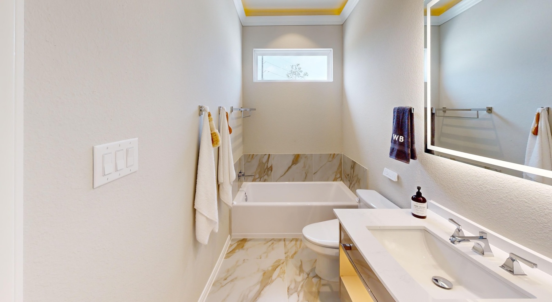 a spacious bathroom with a large mirror and ample light