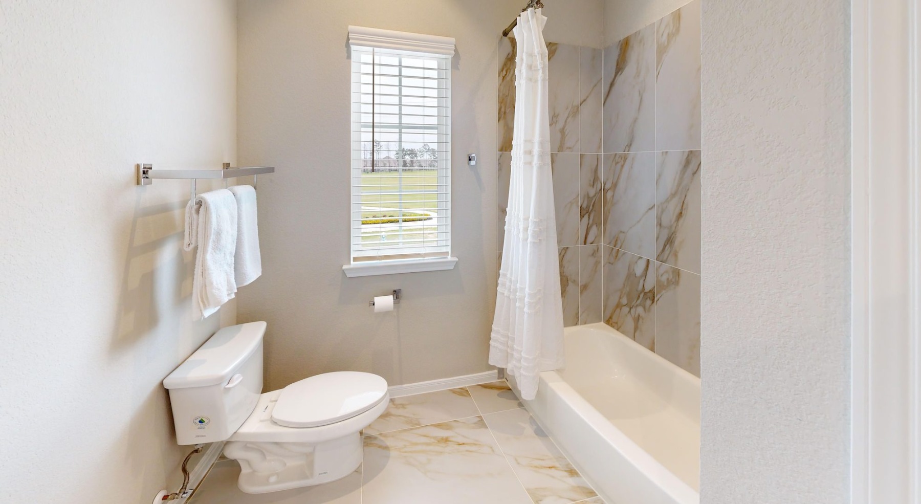 a spacious bathroom with a large mirror and ample light
