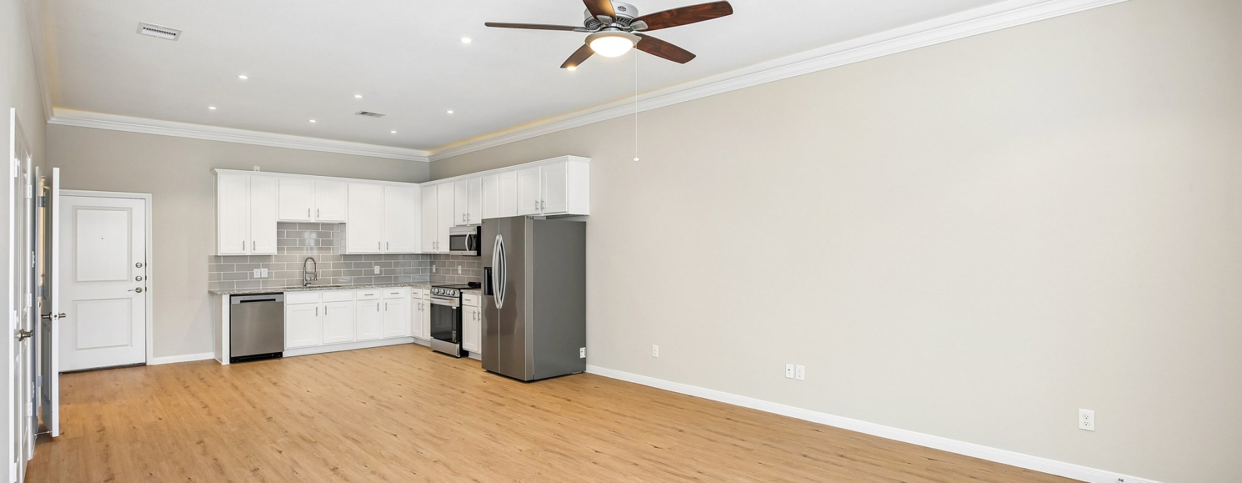 Open-concept living room and kitchen in a 4-bedroom townhome